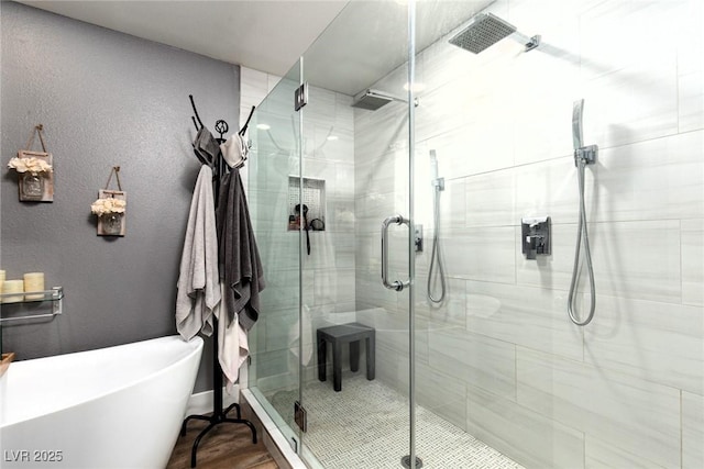 6457 Celeste Ave, Las Vegas, NV 89107 - bathroom featuring a freestanding bath, a shower stall, and a textured wall