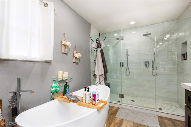 6457 Celeste Ave, Las Vegas, NV 89107 - full bath featuring a stall shower, wood finished floors, a soaking tub, and recessed lighting
