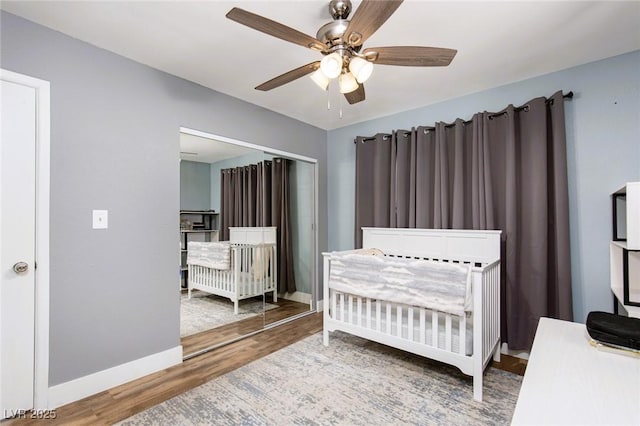 6457 Celeste Ave, Las Vegas, NV 89107 - bedroom with wood finished floors, a crib, and ceiling fan