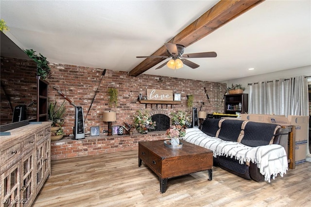 6457 Celeste Ave, Las Vegas, NV 89107 - living area featuring brick wall, ceiling fan, light wood-style flooring, a brick fireplace, and beam ceiling