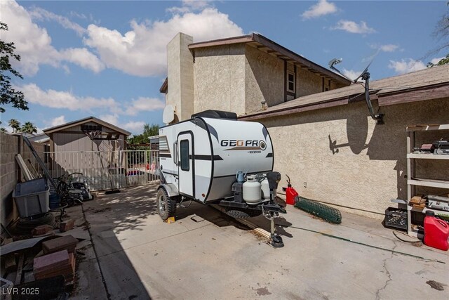 6457 Celeste Ave, Las Vegas, NV 89107 - view of home's exterior featuring stucco siding, a storage shed, and a patio