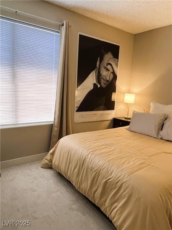 1420 Hialeah Dr Unit D, Las Vegas, NV 89119 - carpeted bedroom with baseboards and a textured ceiling