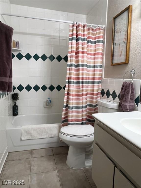 1420 Hialeah Dr Unit D, Las Vegas, NV 89119 - bathroom featuring vanity, shower / bath combination with curtain, tile patterned floors, and tile walls