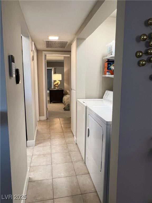 1420 Hialeah Dr Unit D, Las Vegas, NV 89119 - laundry room featuring washer and dryer and light tile patterned floors