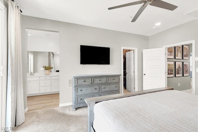 9835 Mojave Mountain St, Las Vegas, NV 89166 - bedroom featuring light colored carpet, connected bathroom, ceiling fan, recessed lighting, and a walk in closet