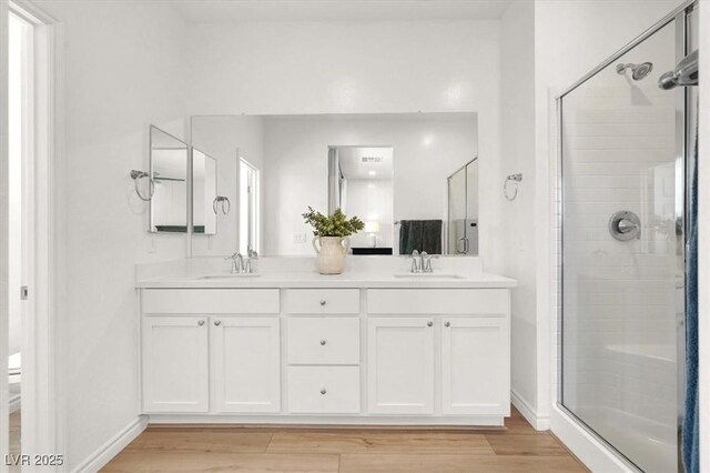 9835 Mojave Mountain St, Las Vegas, NV 89166 - full bathroom featuring a shower stall, double vanity, and wood finished floors