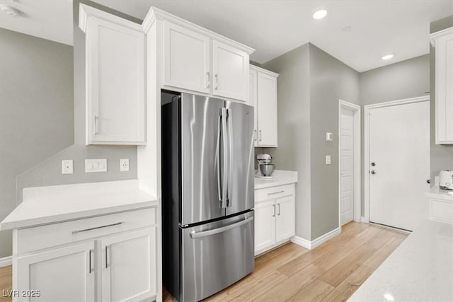 9835 Mojave Mountain St, Las Vegas, NV 89166 - kitchen featuring freestanding refrigerator, light wood-type flooring, white cabinets, and recessed lighting