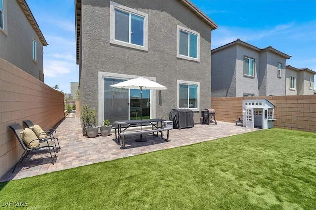 9835 Mojave Mountain St, Las Vegas, NV 89166 - back of property featuring a fenced backyard, a patio, and stucco siding