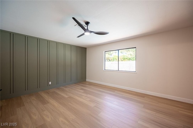 4594 Cabo Ln, Las Vegas, NV 89121 - spare room featuring light wood-type flooring, a ceiling fan, and a decorative wall
