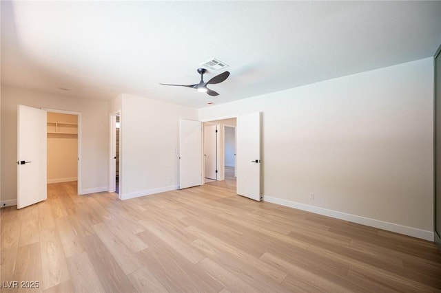 4594 Cabo Ln, Las Vegas, NV 89121 - unfurnished bedroom with light wood-style floors, a walk in closet, and ceiling fan