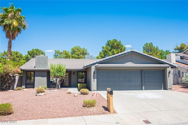 4594 Cabo Ln, Las Vegas, NV 89121 - ranch-style home featuring a tile roof, driveway, a garage, and stucco siding