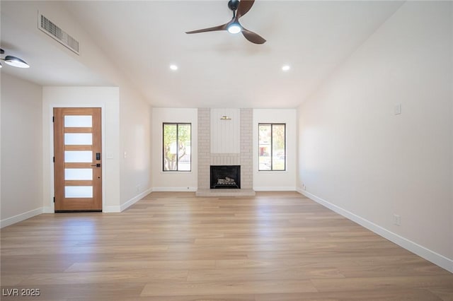 4594 Cabo Ln, Las Vegas, NV 89121 - unfurnished living room featuring a ceiling fan, light wood-style floors, lofted ceiling, recessed lighting, and a brick fireplace