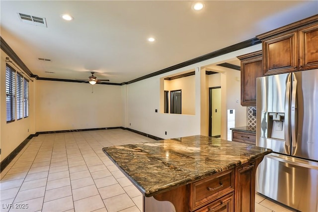 235 Calvino Ave, Las Vegas, NV 89183 - kitchen featuring stainless steel fridge, a ceiling fan, crown molding, light tile patterned floors, and a kitchen island