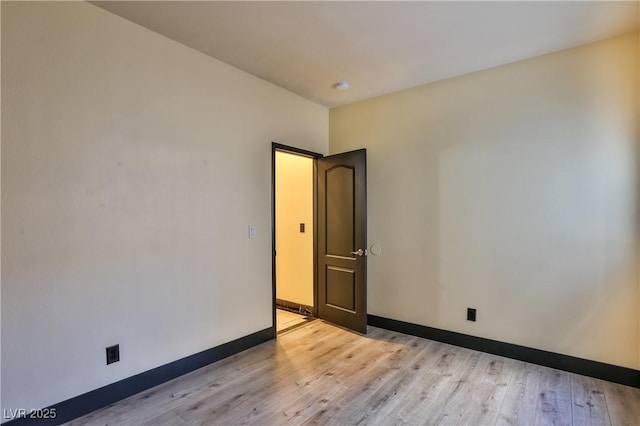235 Calvino Ave, Las Vegas, NV 89183 - empty room with light wood finished floors and a smoke detector