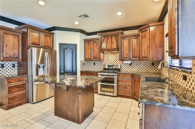 235 Calvino Ave, Las Vegas, NV 89183 - kitchen with stainless steel appliances, premium range hood, tasteful backsplash, light tile patterned floors, and recessed lighting