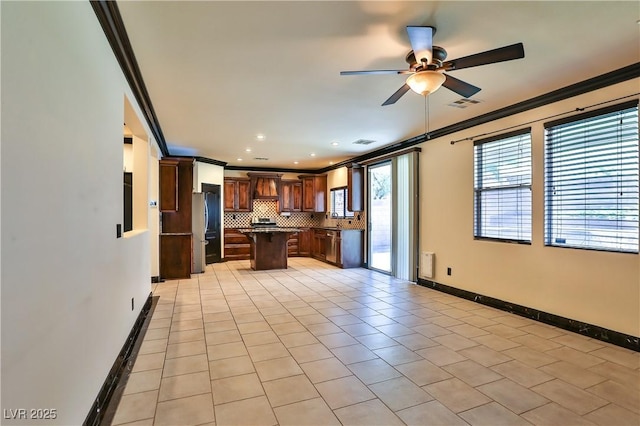 235 Calvino Ave, Las Vegas, NV 89183 - kitchen featuring freestanding refrigerator, ornamental molding, custom exhaust hood, a ceiling fan, and a center island
