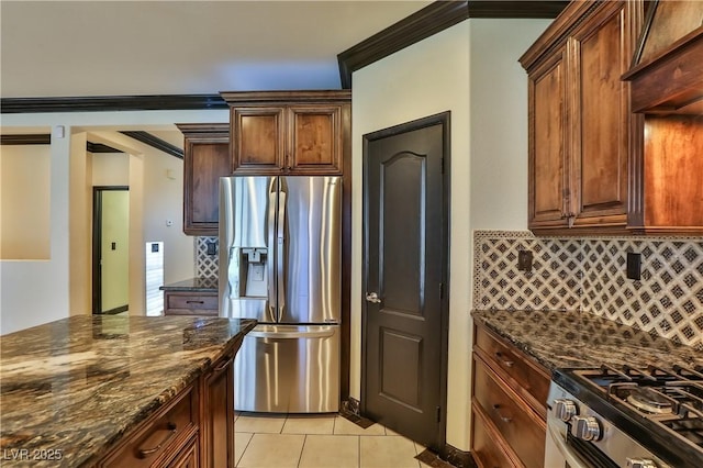 235 Calvino Ave, Las Vegas, NV 89183 - kitchen with appliances with stainless steel finishes, dark stone counters, tasteful backsplash, light tile patterned floors, and crown molding