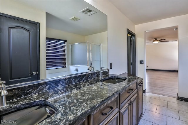 235 Calvino Ave, Las Vegas, NV 89183 - bathroom with double vanity, ceiling fan, a stall shower, and tile patterned floors
