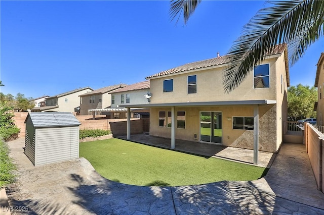 235 Calvino Ave, Las Vegas, NV 89183 - rear view of property with stucco siding, a shed, a fenced backyard, and a patio area