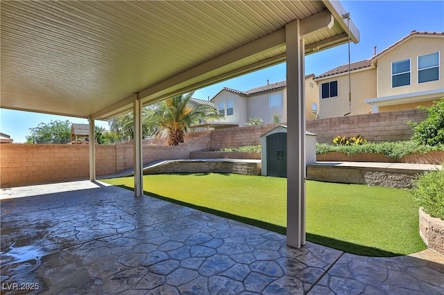 235 Calvino Ave, Las Vegas, NV 89183 - fenced backyard with a patio area and a shed