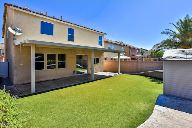 235 Calvino Ave, Las Vegas, NV 89183 - rear view of property with a fenced backyard, stucco siding, and a patio area