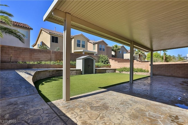 235 Calvino Ave, Las Vegas, NV 89183 - fenced backyard featuring a patio, a shed, and a residential view