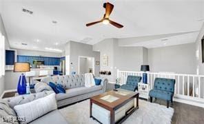 11018 Salernes St, Las Vegas, NV 89141 - living area featuring a ceiling fan and baseboards