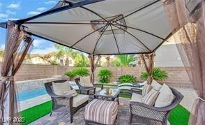 11018 Salernes St, Las Vegas, NV 89141 - fenced backyard with outdoor lounge area, a gazebo, and a patio area