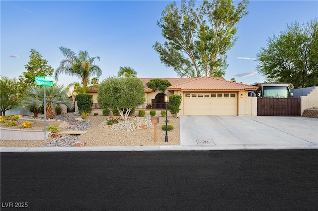 3227 Paintedhills Ave, Las Vegas, NV 89120 - view of front of home featuring stucco siding, an attached garage, concrete driveway, a tiled roof, and a gate