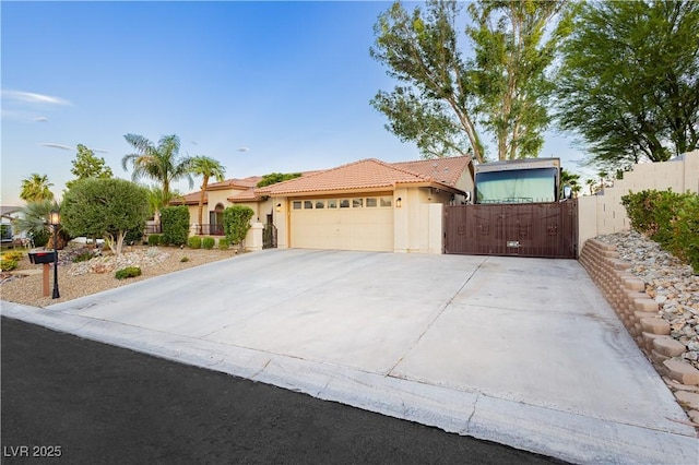 3227 Paintedhills Ave, Las Vegas, NV 89120 - view of front of home with a tiled roof, stucco siding, a garage, a gate, and concrete driveway