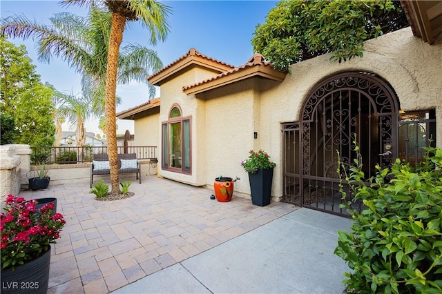 3227 Paintedhills Ave, Las Vegas, NV 89120 - doorway to property with stucco siding, a patio area, a gate, and a tile roof
