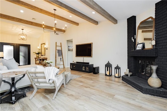3227 Paintedhills Ave, Las Vegas, NV 89120 - living room with a chandelier, wood finished floors, beam ceiling, recessed lighting, and a fireplace
