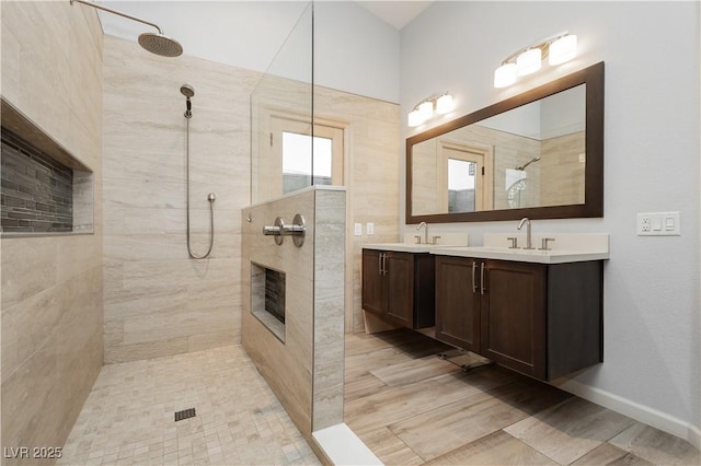 3227 Paintedhills Ave, Las Vegas, NV 89120 - bathroom featuring a walk in shower, double vanity, a fireplace, and wood finished floors