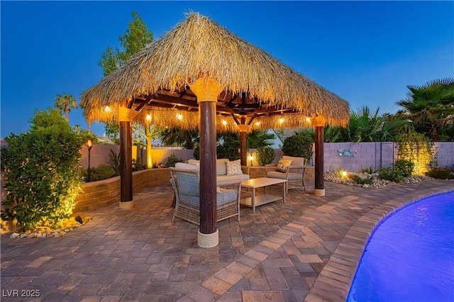 3227 Paintedhills Ave, Las Vegas, NV 89120 - patio at night with a gazebo, a fenced backyard, a patio area, and outdoor lounge area