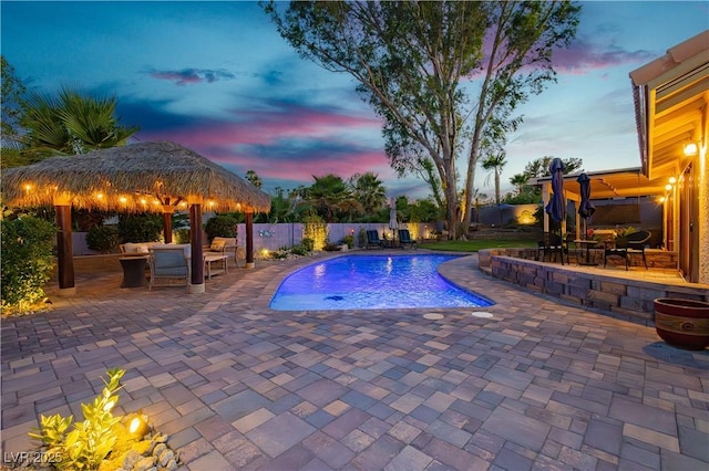 3227 Paintedhills Ave, Las Vegas, NV 89120 - pool at dusk with a gazebo, a patio, and a fenced backyard