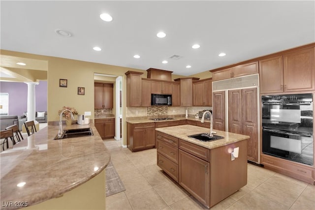 9516 Bluff Ledge Ave, Las Vegas, NV 89149 - kitchen with black appliances, light stone countertops, backsplash, decorative columns, and recessed lighting