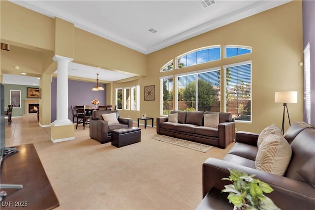 9516 Bluff Ledge Ave, Las Vegas, NV 89149 - living area with decorative columns, a towering ceiling, and light colored carpet
