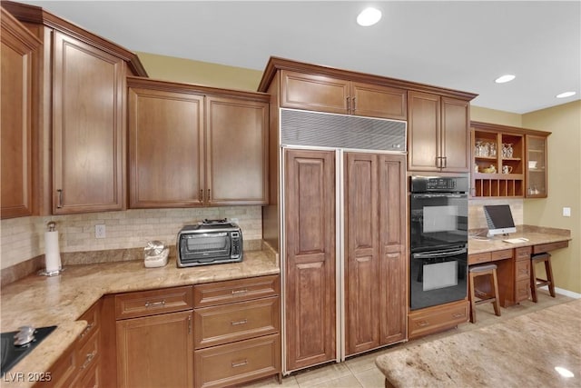 9516 Bluff Ledge Ave, Las Vegas, NV 89149 - kitchen with black appliances, backsplash, built in desk, and recessed lighting