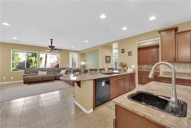 9516 Bluff Ledge Ave, Las Vegas, NV 89149 - kitchen with black dishwasher, ceiling fan, light stone counters, decorative backsplash, and recessed lighting