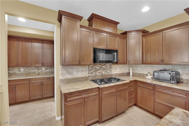 9516 Bluff Ledge Ave, Las Vegas, NV 89149 - kitchen featuring black microwave, gas stovetop, light tile patterned flooring, backsplash, and recessed lighting