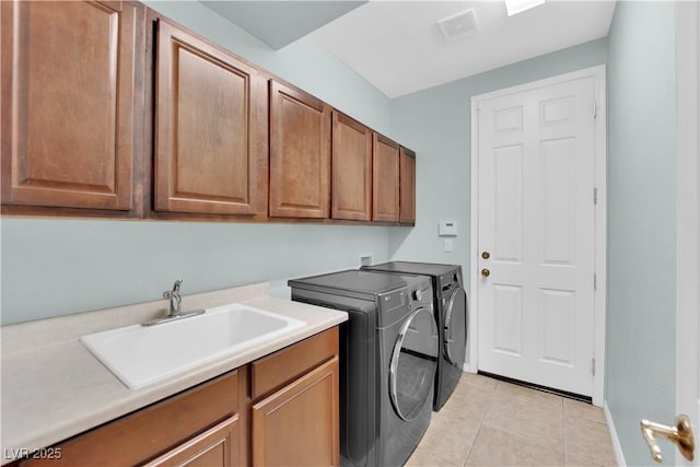 9516 Bluff Ledge Ave, Las Vegas, NV 89149 - laundry room featuring washing machine and clothes dryer, cabinet space, and light tile patterned flooring