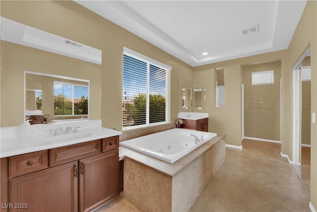 9516 Bluff Ledge Ave, Las Vegas, NV 89149 - full bathroom with two vanities, a tub with jets, a raised ceiling, and tile patterned floors
