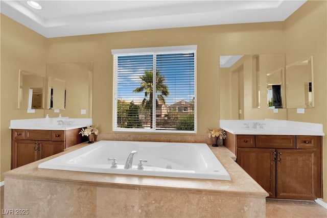 9516 Bluff Ledge Ave, Las Vegas, NV 89149 - full bath with two vanities, a jetted tub, and tile patterned flooring