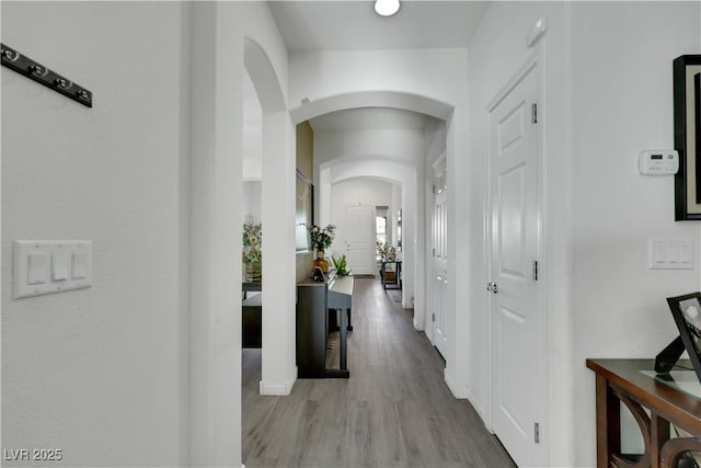 10167 Bishops Peak Ct, Las Vegas, NV 89141 - corridor featuring arched walkways and wood finished floors