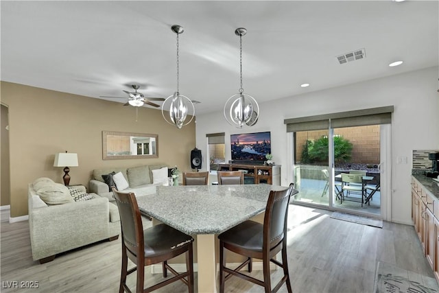 10167 Bishops Peak Ct, Las Vegas, NV 89141 - dining area with a chandelier, light wood-style flooring, a ceiling fan, and recessed lighting