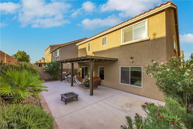 10167 Bishops Peak Ct, Las Vegas, NV 89141 - back of property with stucco siding, a fire pit, a pergola, a patio area, and a fenced backyard