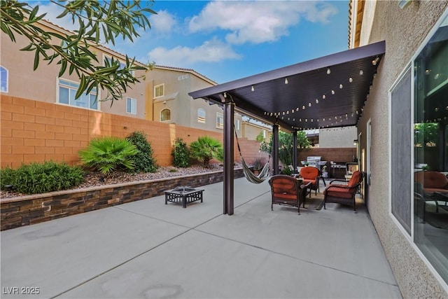 10167 Bishops Peak Ct, Las Vegas, NV 89141 - fenced backyard with a patio and an outdoor living space with a fire pit
