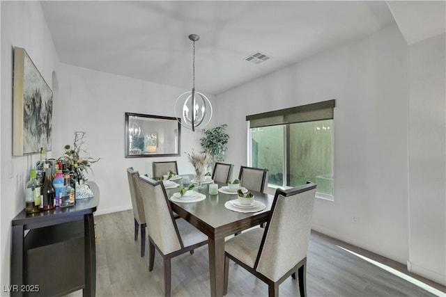 10167 Bishops Peak Ct, Las Vegas, NV 89141 - dining room featuring a chandelier and wood finished floors