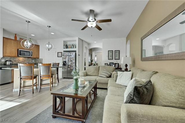 10167 Bishops Peak Ct, Las Vegas, NV 89141 - living room with arched walkways, ceiling fan, light wood-type flooring, and recessed lighting