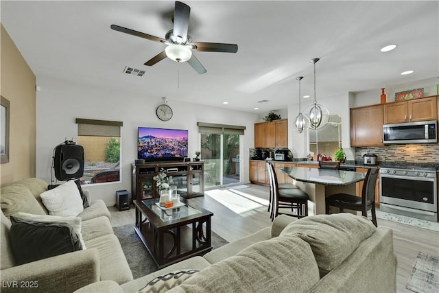 10167 Bishops Peak Ct, Las Vegas, NV 89141 - living area featuring light wood finished floors, ceiling fan, recessed lighting, and a chandelier